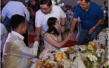 <p><strong>MASS WEDDING.</strong> General Trias City Mayor Antonio Ferrer (in polo barong) congratulates one of the 48 newly-wed couples at the reception following the free mass wedding he solemnized and acted as godfather at the GenTri Cultural and Convention Center in Cavite City on Friday (June 22, 2018). <em>(Photo by Dennis Abrina)</em></p>